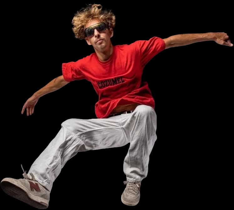 Jimmy Sundays mid-kickflip in a red tee and white pants